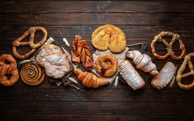 Wallpaper from different types of pastries on brown boards. For decoration of bakery sales outlets....