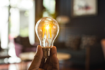 A hand holding is light bulb for save energy. Creative ideas concept, lightbulb for new idea, object design for thinking