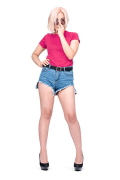 A young pretty Asian girl in a pink T-shirt, denim shorts holds sunglasses on her face with her finger, isolated on a transparent background png.