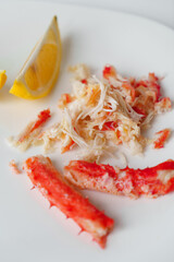 Crab meat and lemon on a white plate