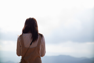 Back scene of woman alone with feeling lonely and depressed on blurred background of beautiful...