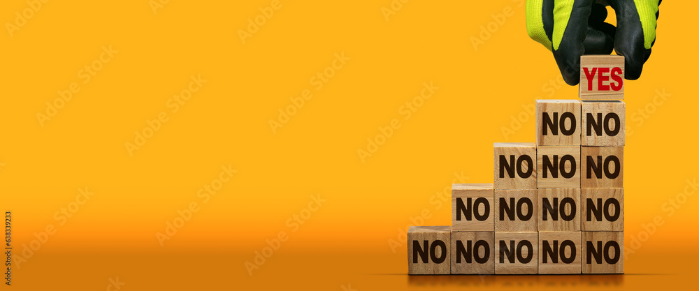 Poster gloved hand arranging wood blocks with brown text no as step with a red text yes on the last step. o