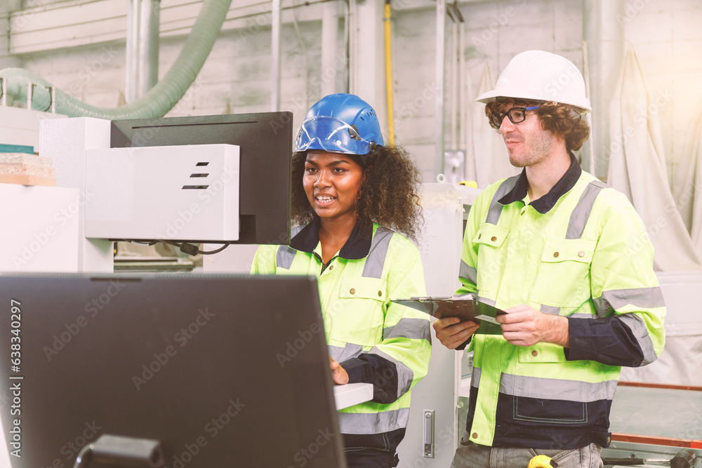 Poster portrait of an engineering team of men and women in safety uniforms. use computers to check and cont