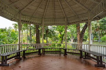 A wooden old round gazebo is a place to relax in a tropical public city Chatuchak Park or in botanical garden in Bangkok. View from inside