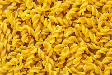 Raw Macaroni pasta, textured background
