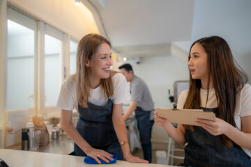 Barista workers are prepared at the counter pantry of coffee. Man and women enjoy their work....