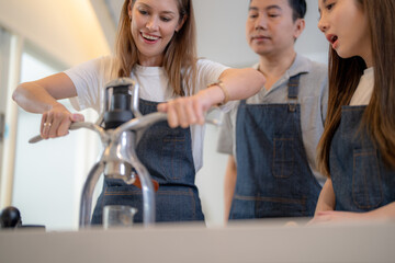 Barista workers are tasting coffee drinks at the counter pantry of coffee. Man and women enjoy...