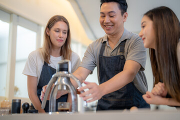 Barista workers are tasting coffee drinks at the counter pantry of coffee. Man and women enjoy...