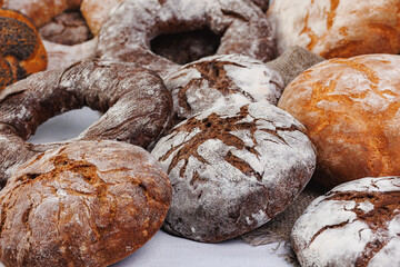 Different types of artisan craft bread in bakery store shelves