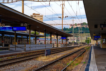 Diminishing perspective of railway tracks at railway station of City of Lenzburg on a late spring evening. Photo taken June 7th, 2023, Lenzburg, Switzerland.