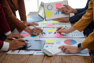 Business team collaboration discussing working analyzing with financial data and marketing growth report graph in team, presentation and digital tablet, laptop