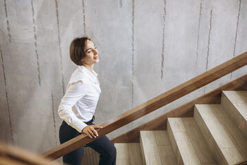 Business woman walking the hotel stairs to her room