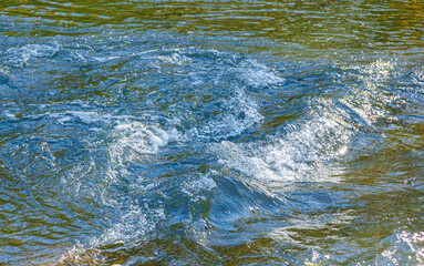 flow of water and spray from a stone