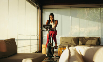 Woman exercising on stationary bike for a healthy lifestyle