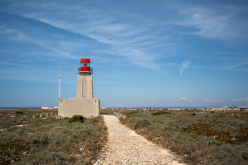 Fototapeta na wymiar Sagres Fortress lighthouse on a blue sky day