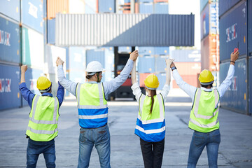 Fototapeta premium back view engineers or factory workers holding hands together for success work or project in containers warehouse storage