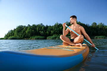 Man paddle boarding on SUP board in river