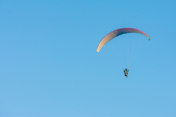 paragliding free flying in a blue sky day