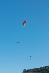 Fototapeta na wymiar group of paragliders flying on a sunny day