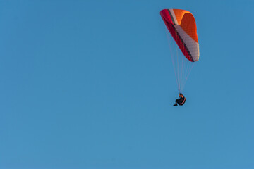 colorful paraglider flying with blue sky