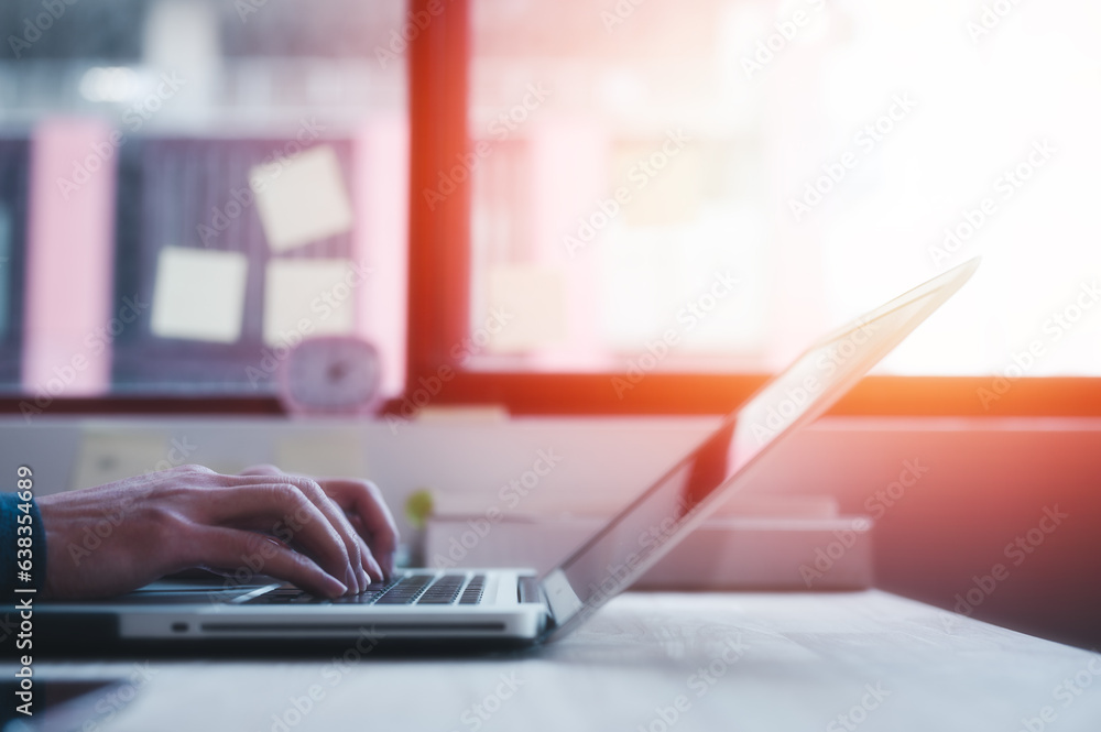 Poster hands typing on laptop while sitting at office desk indoors, man fingers tapping and texting on comp
