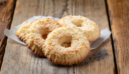Traditional italian coconut cookies on the wooden table, selective focus