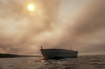 The sun barely peeks out of the clouds from forest fires on a hot day in Greece, Kassandra peninsula