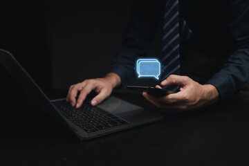 Person with hologram chatting, businessman texting, communicating through smartphone application, online messaging on internet, using social media. The concept of using technology in communication.