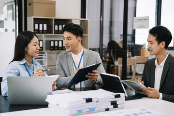 Businessmen team or financial data analysts working with tablets and laptop computers and data graphs together. Plan to analyzing projects in the office.