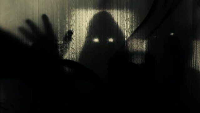 Silhouettes of three hooded people with luminous eyes behind a transparent curtain in clouds of thick black smoke, raising their heads and stretching their arms. Concept of demons, paranormal, ghosts.