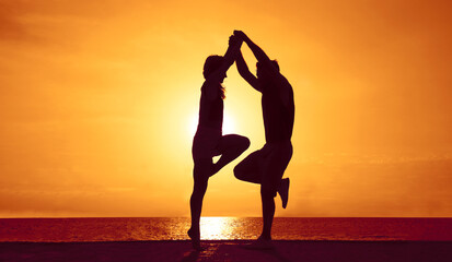 couple in love. Silhouette of couple dancing during sunset. Bachata dance. playful young couple having fun on the beach at sunset. Golden hour. woman dancу with man turning woman leading her into dip