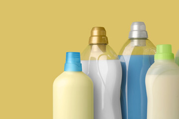 Bottles of fabric softener on yellow background, space for text