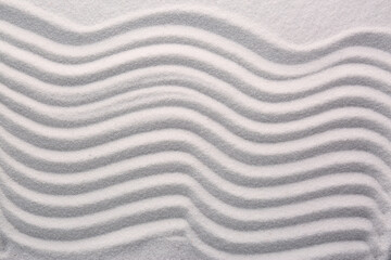 White sand with pattern as background, top view. Concept of zen and harmony