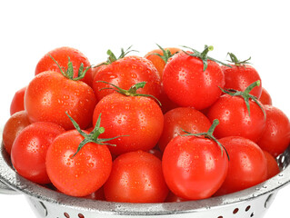 Colander with fresh ripe cherry tomatoes isolated on white