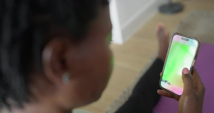 Woman exercising with mobile app at home