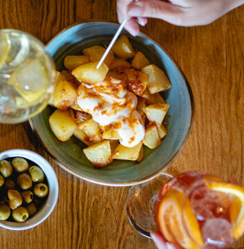 Mediterranean Temptations: Aperitivo Delights with Patatas Bravas, Olives, Vermut, and Aperol