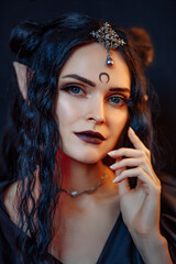 Beautiful black haired demon girl in seylor moon style. Dark elf girl in black dress on black...