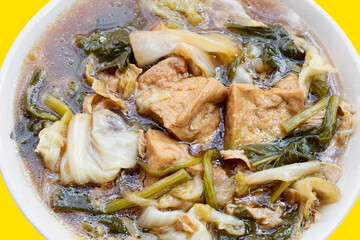 Mixed vegetable stew with tofu in white bowl (Tom Jub Chai)