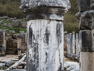 Close-up of an ancient Greek inscription on a column in the ruins of the ancient city of Perge in...