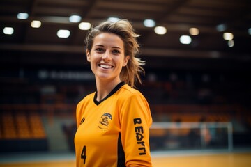 Portrait of a female volleyball player smiling at the camera at the stadium