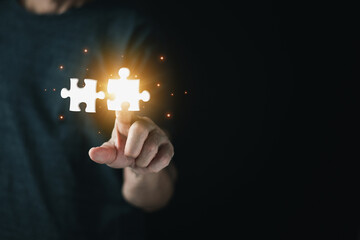 Business solutions, man hands touching jigsaw puzzle icon, target, success, goals and strategy concepts, Mergers and acquisition concept with consultant holding puzzle pieces icons.