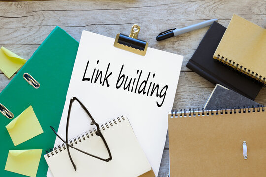 LINK BUILDING text on white a4 paper. green folder