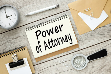 power of attorney gray wooden table clock background. text on notepad