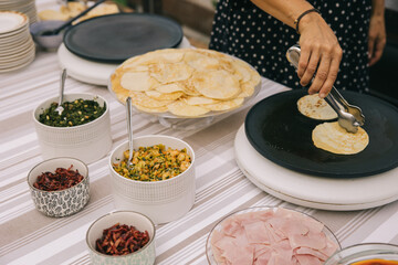 Close up of a pancake buffet in a wedding. Healthy vegetables crepe corner