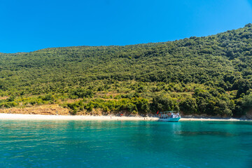  Kakome beach seen from the boat on the Albanian riviera near Sarande and its turquoise waters, Albania
