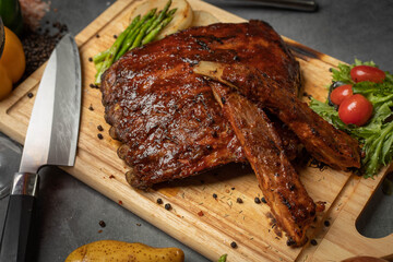 Grilled marbled rib eye steak with green asparagus. Roasted barbecued pork.	
