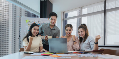 Group of designer cheerful giving high five on the success of website design and application on mobile