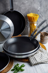 pots and pans in the kitchen, on a gray background