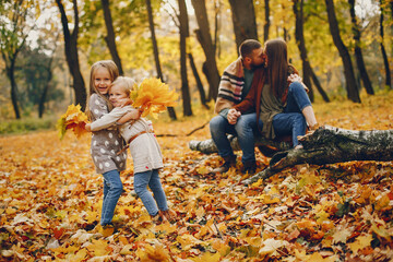 Family with cute kids in a autumn park