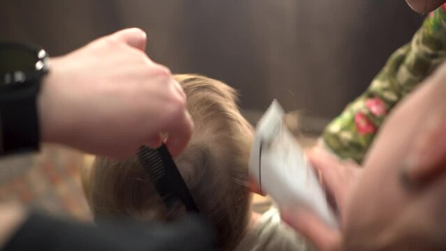 A small child is having a haircut. 